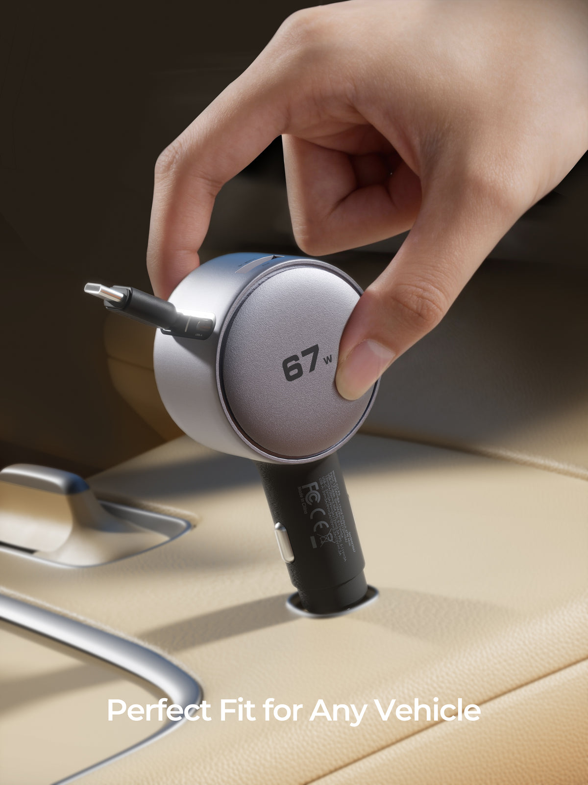 A hand inserts a silver and black 67W car USB-C charger into a cigarette lighter port in a beige car interior. White text at the bottom reads 'Perfect Fit for Any Vehicle'.
